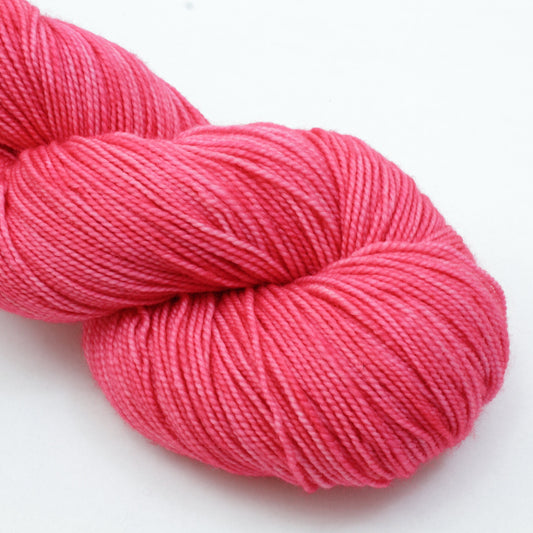 Pink skein of yarn on a white background