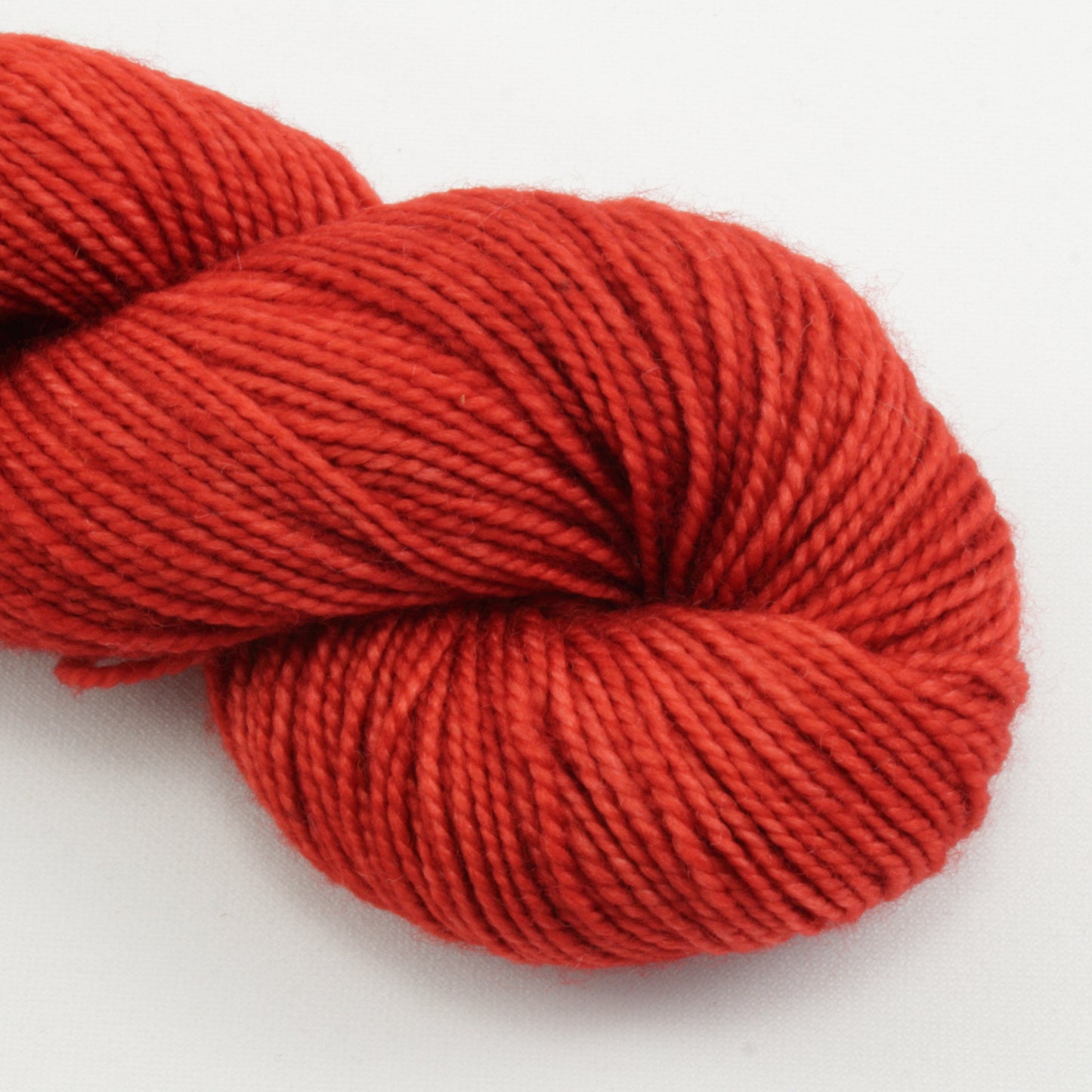 Red skein of yarn on a white background